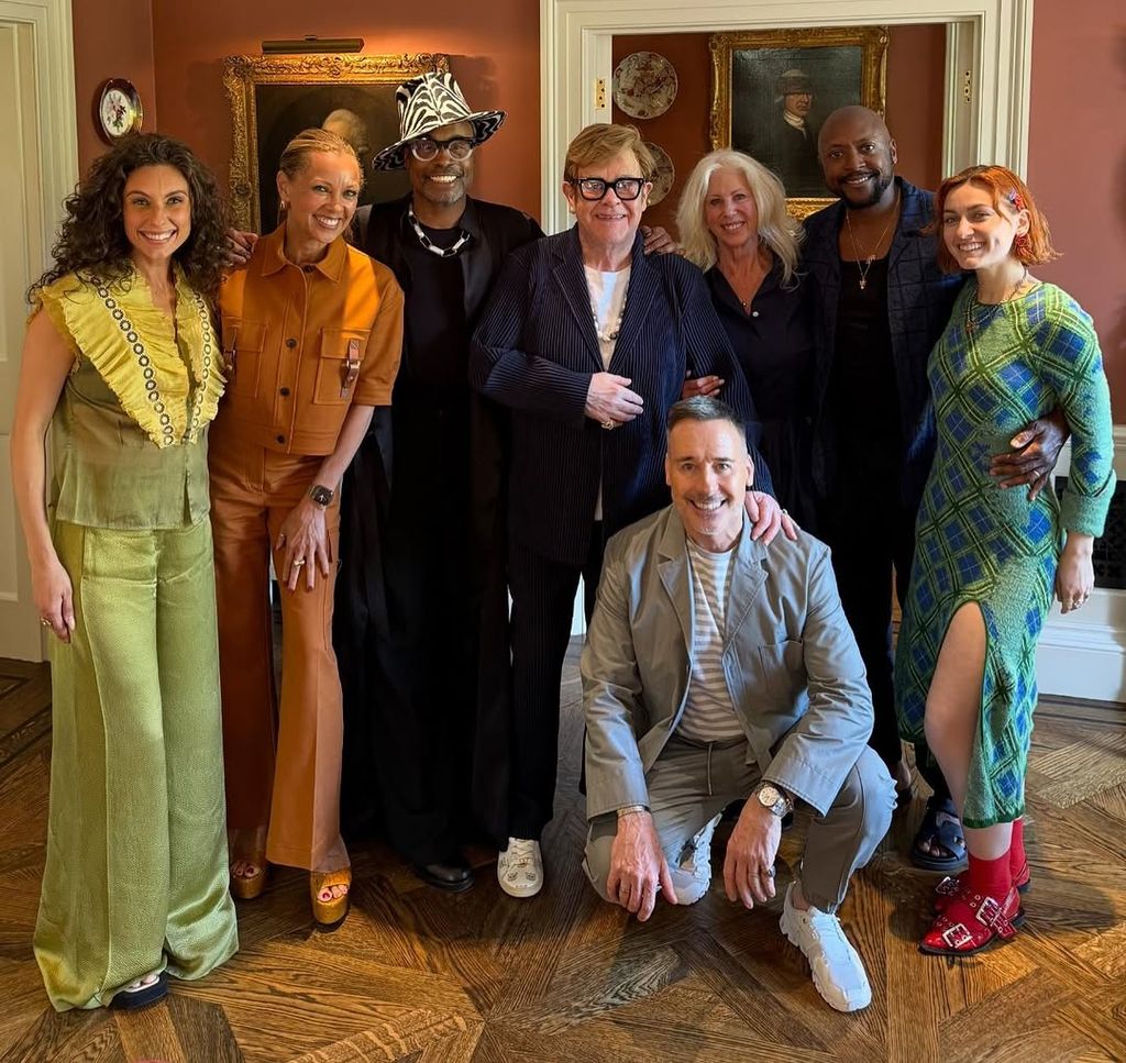 Elton John and David Furnish smiling for photo while standing with their friends in dining room of windsor home