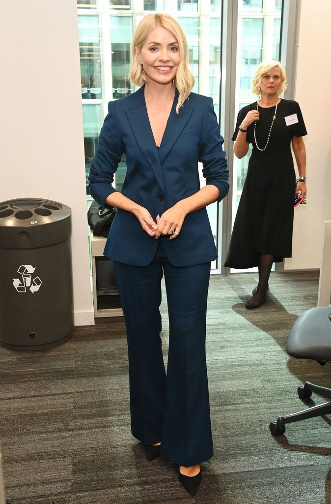 Holly posed in navy suit in office