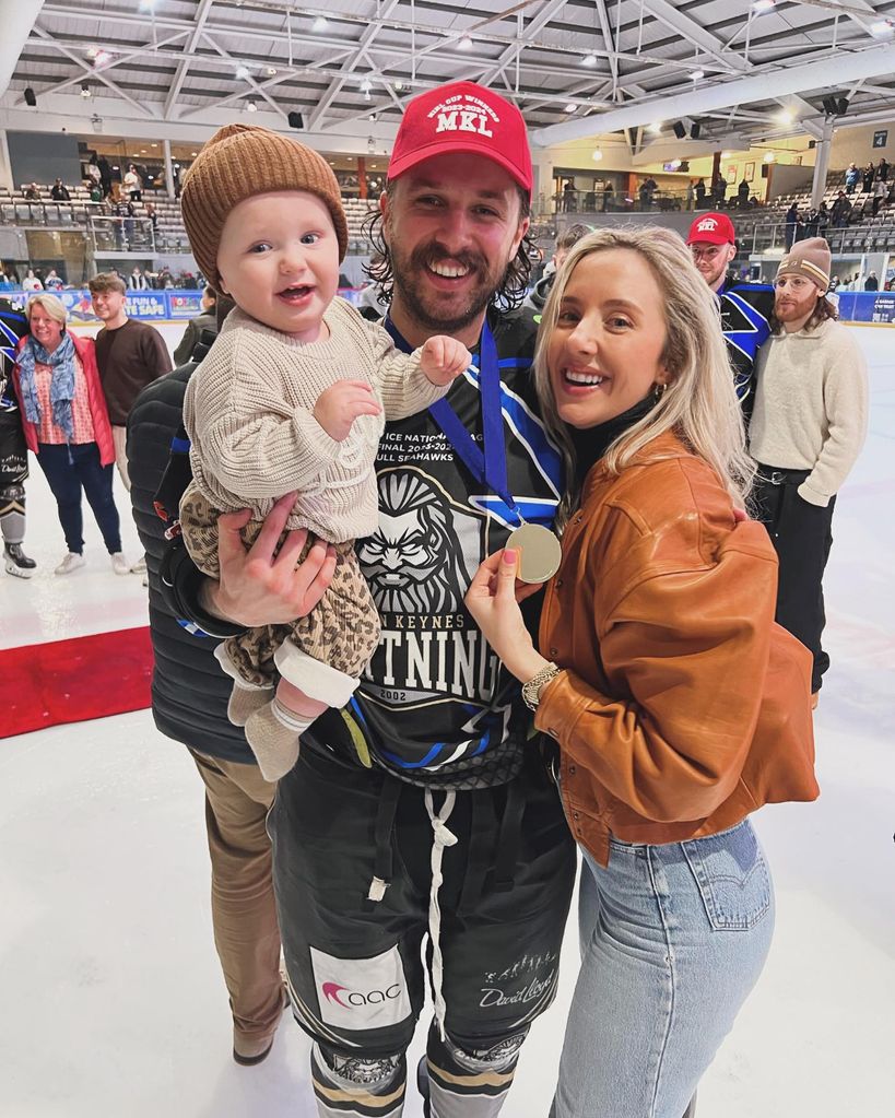 Liam with wife and baby on ice rink