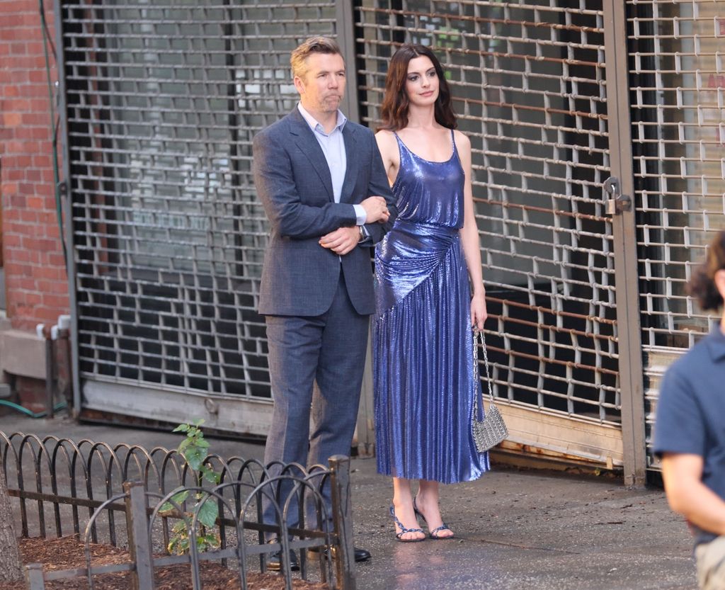 Anne Hathaway wearing a blue metallic dress on The Devil Wears Prada 2