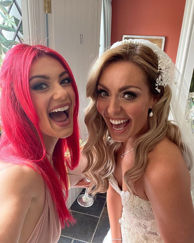 Dianne Buswell in a pink bridesmaids dress with Amy Dowden in a wedding dress