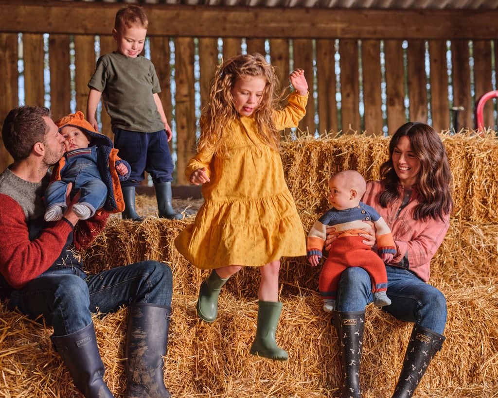 Kelvin and Liz Fletcher's with their kids in a barn