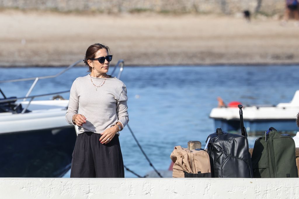 Crown Princess Mary was seen on the port with luggage before boarding a boat to take the family to the yacht