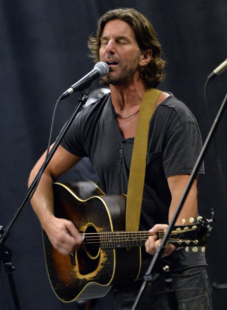 photo of brett james singing on stage with guitar
