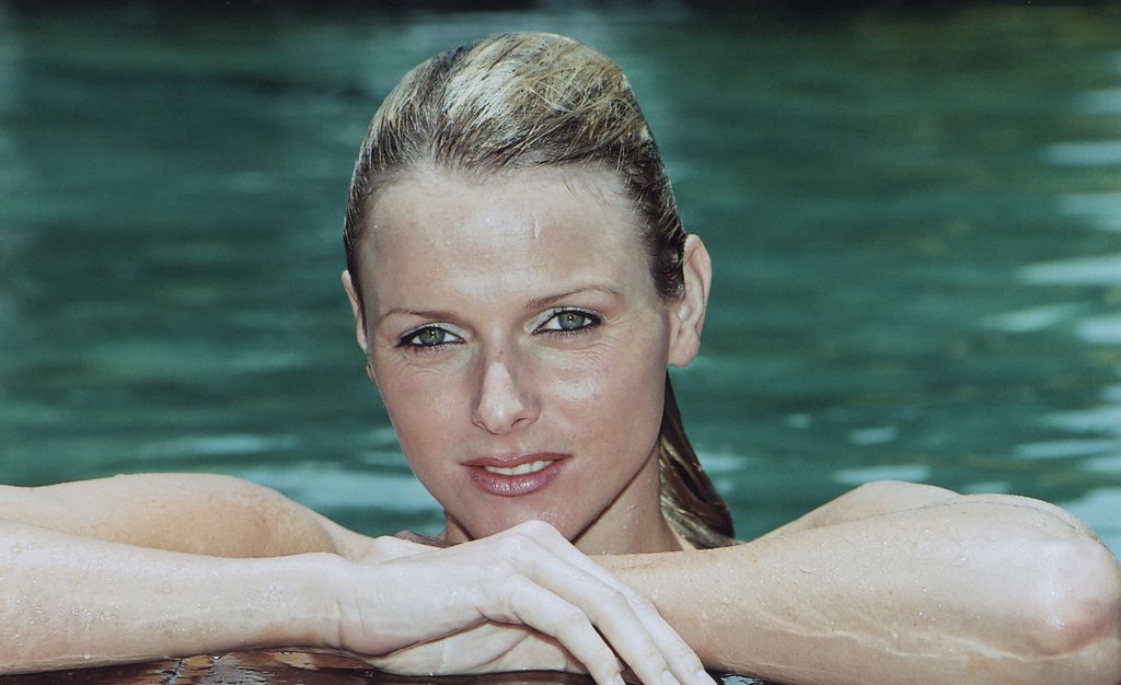 Princess Charlene resting her head on her hands in the swimming pool