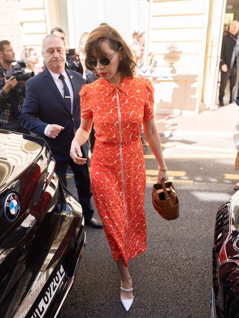 Aubrey Plaza is seen during the 77th Cannes Film Festival on May 17 in an orange midi dress