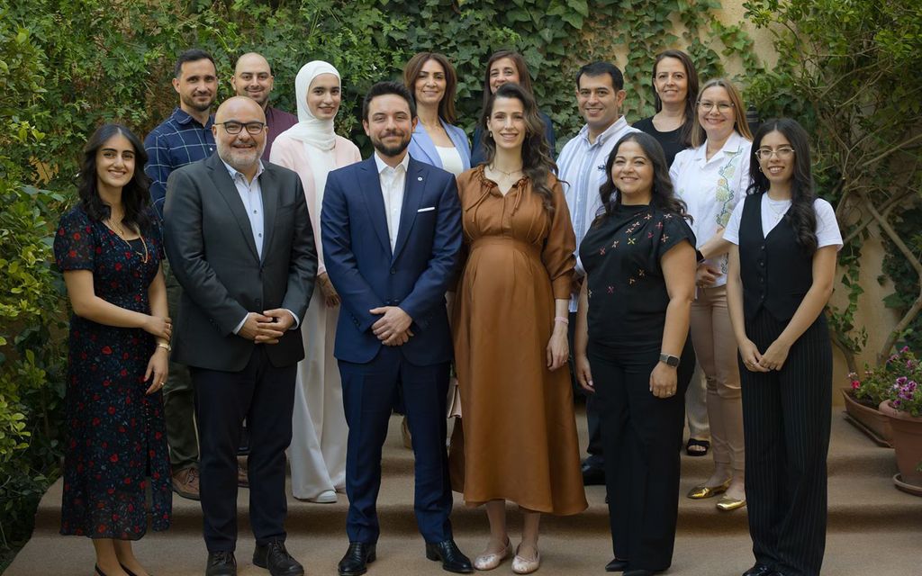 Pregnant Princess Rajwa wearing brown dress