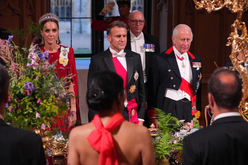 Britain's King Charles III (R), France's President Emmanuel Macron and Britain's Catherine, Princess of Wales stand for national anthem