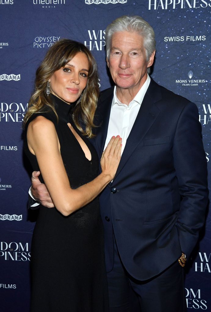 richard gere in navy suit alejandra silva in black dress hugging