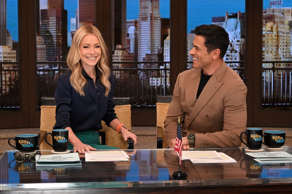  Kelly Ripa and Mark Consuelos captured laughing together at their hosting desk