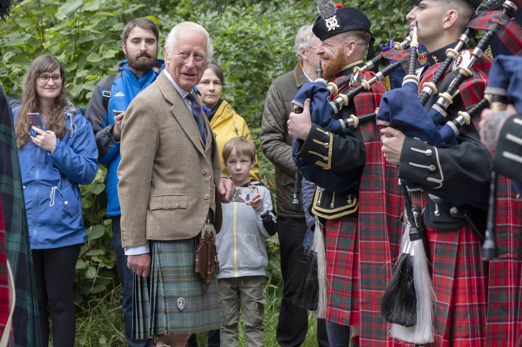 King Charles III meets members of the Band of The Royal Regiment of Scotland and the Pipes and Drums of the Royal Corps of Signals