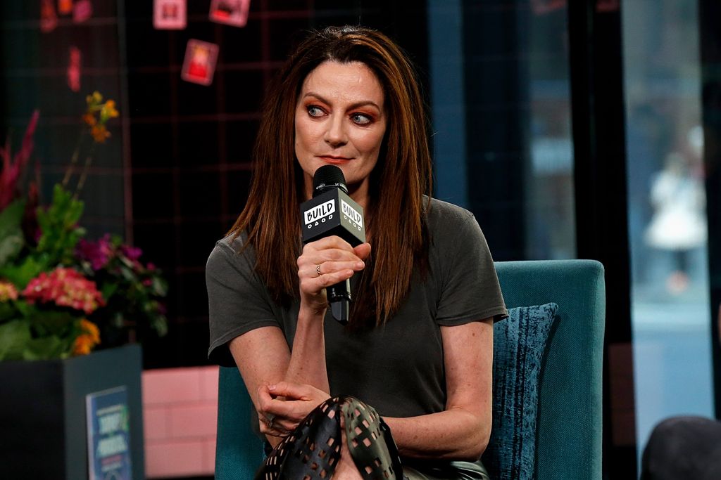 Michelle Gomez holding a microphone