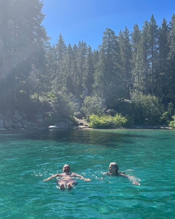 Gary Barlow and wife Dawn swimming in a lake 