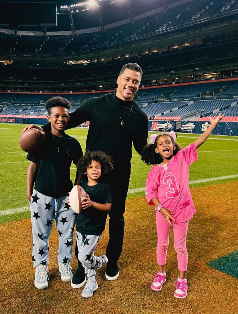 Photo shared by Ciara on Instagram October 2023 of her husband Russell Wilson posing with her kids Future, Sienna and Win on a football field