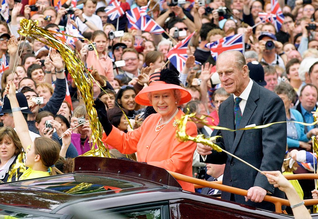 Queen Elizabeth II and Prince Phillip the Duke of Edinburgh ride along the Mall in an open top car on their way to watch a parade in celebration of the Golden Jubilee on June 4, 2002
