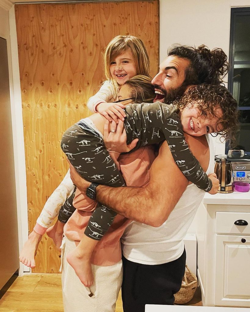 Justin Baldoni and Emily Baldoni hoist up their two kids Maxwell and Maiya, shared on Instagram