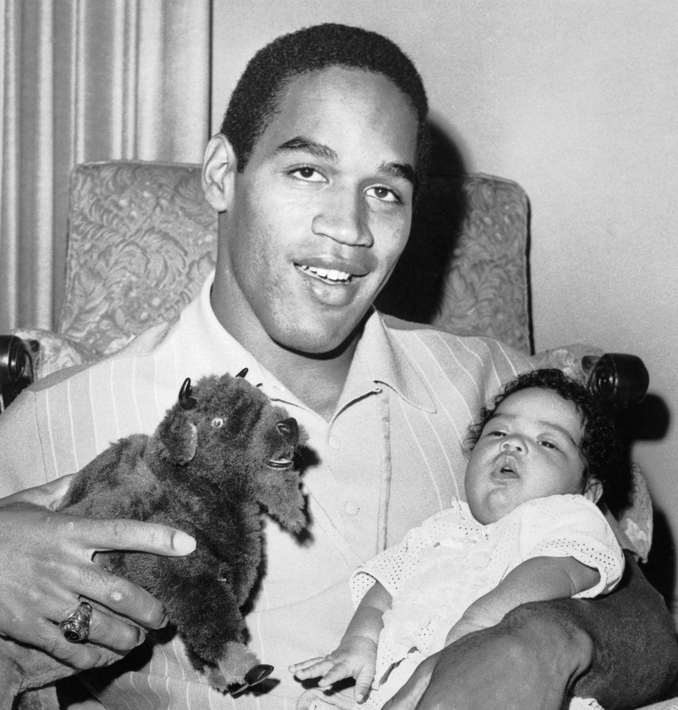 (Original Caption) Arnelle Simpson, two-month-old daughter of Heisman Trophy winner O.J. Simpson, does not seem too interested in her father or the toy buffalo he is holding following his selection by the Buffalo Bills as the clubs number one choice in the pro football draft.