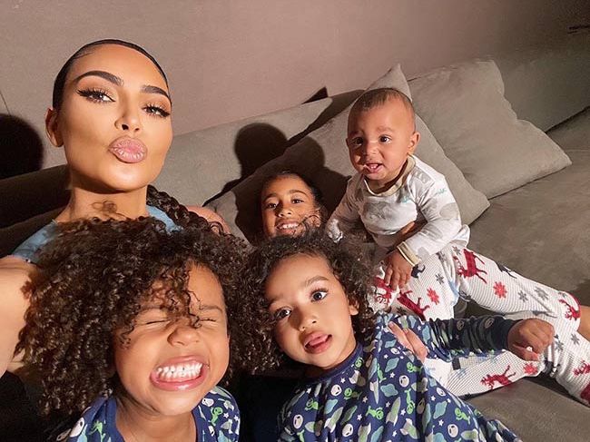 kim kardashian with her four children on sofa