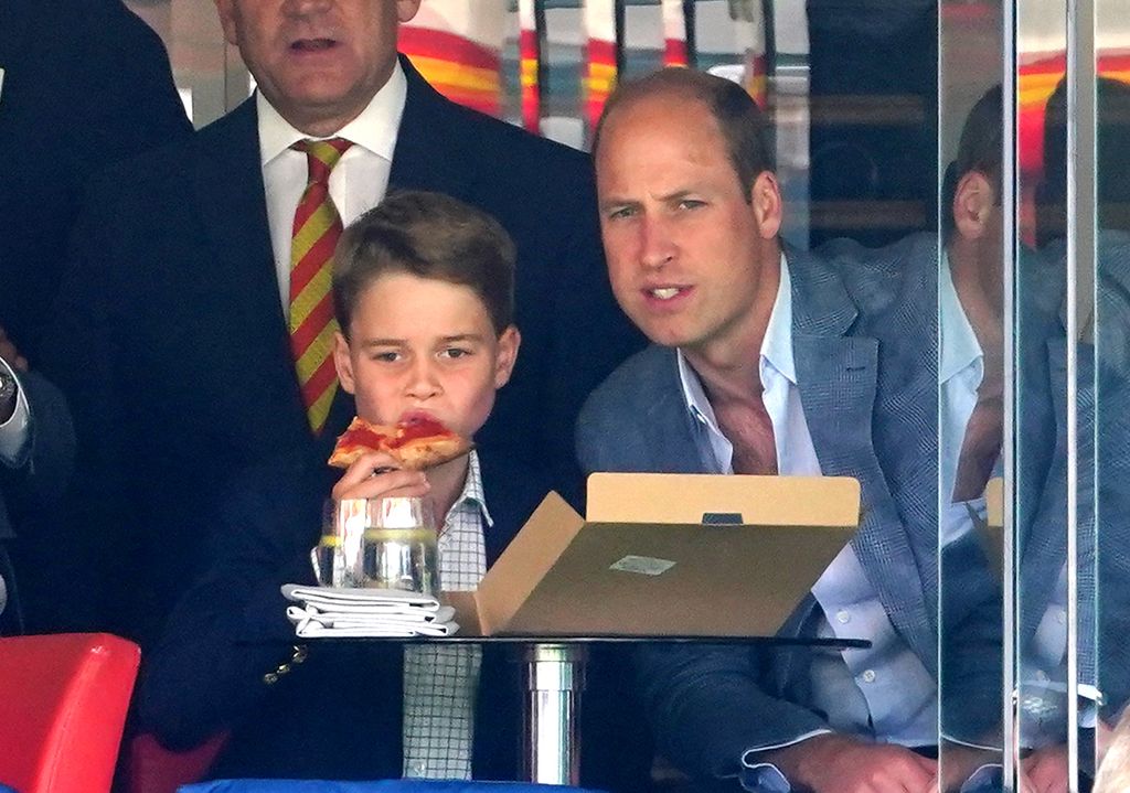 Prince George eats pizza on a day out at the Ashes with Prince William
