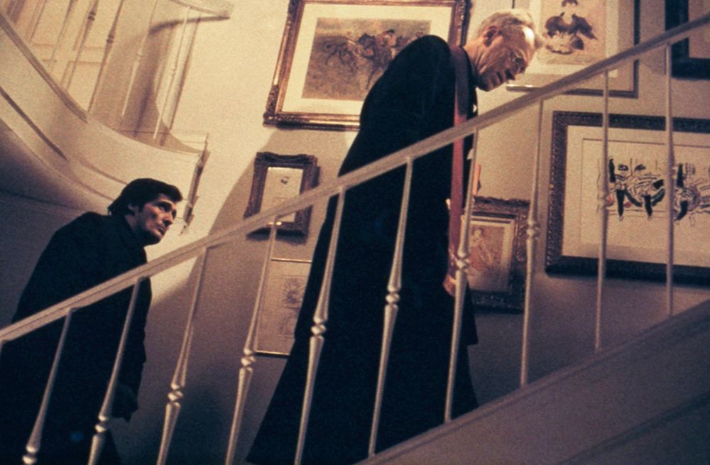 Jason Miller and Max Von Sydow climb staircase in the MacNeil house