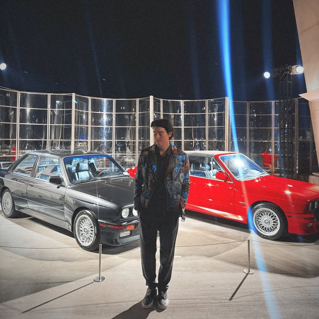 Paris Brosnan poses next to BMW E30s after his live painting event at Art Basel in Miami, shared on Instagram