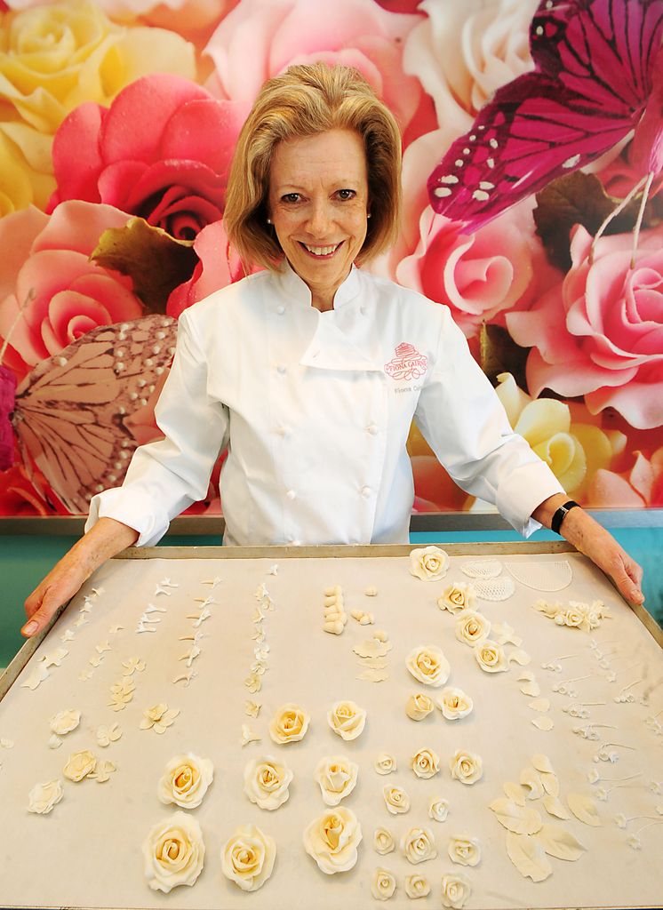 Cake designer Fiona Cairns holds a tray of decorations for the cake