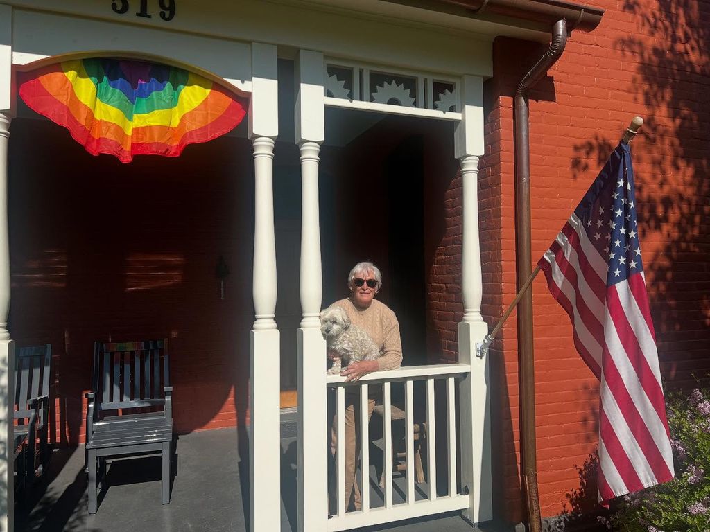 photo of glenn close standing on her porch at montana home beside her dog