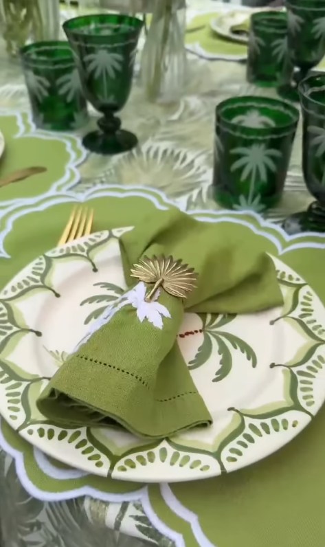 Dining table laid out with green botanical theme