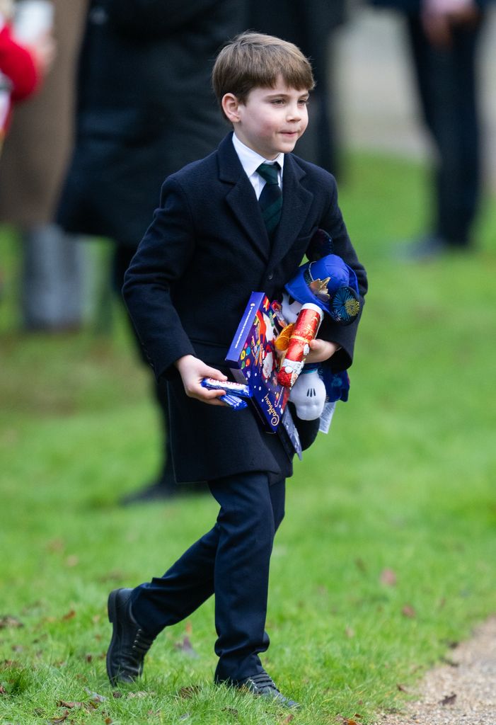 Prince Louis carrying presents 
