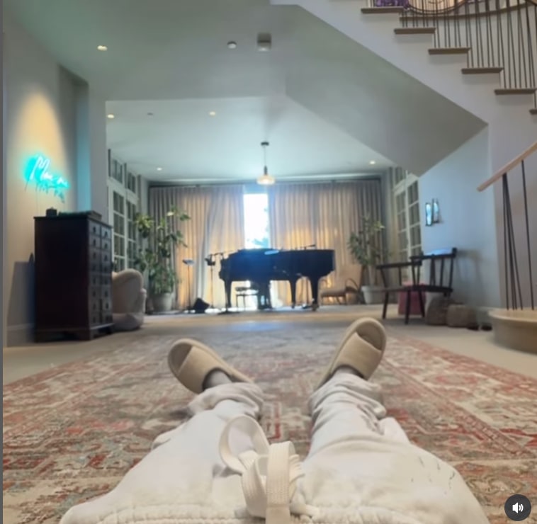 Justin's feet in shot of entryway with piano