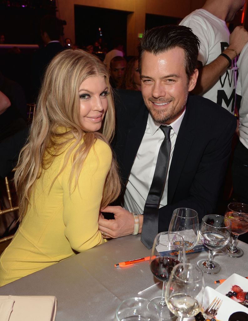 Fergie and actor Josh pose together at a table at the "TrevorLIVE LA" in 2013