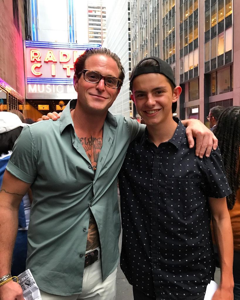 Cameron with arm around Dylan Douglas on new york street