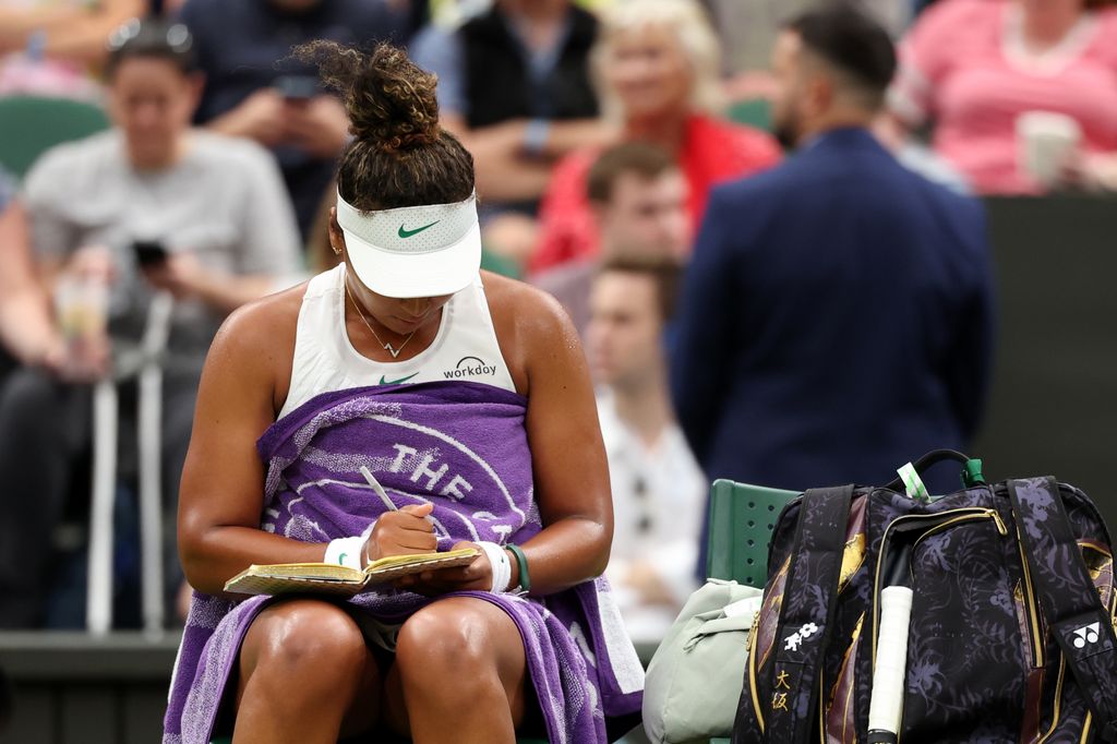 Naomi Osaka writing in a journal at Wimbledon 2024