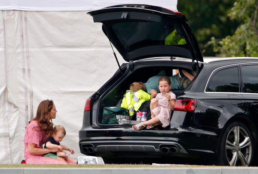 Kate, Louis, George and Charlotte eating lunch in boot of car