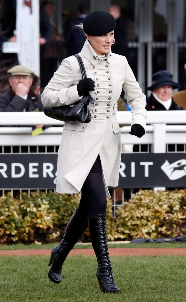 Zaratindal portant des bottes à lacets brevetées noires et une veste blanche