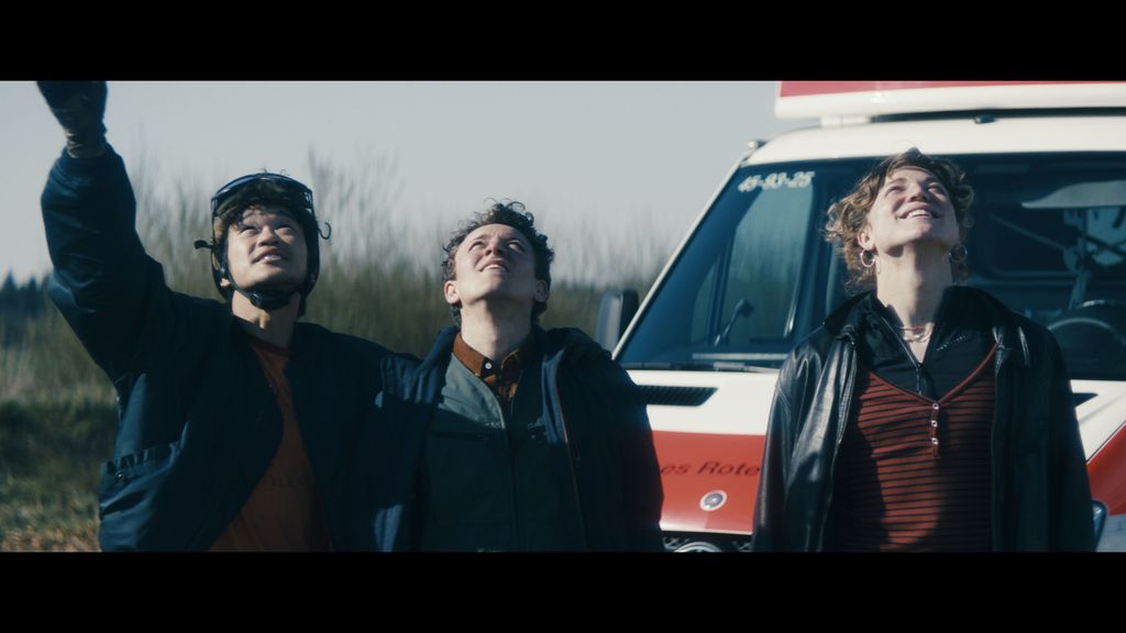 three young men looking at sky