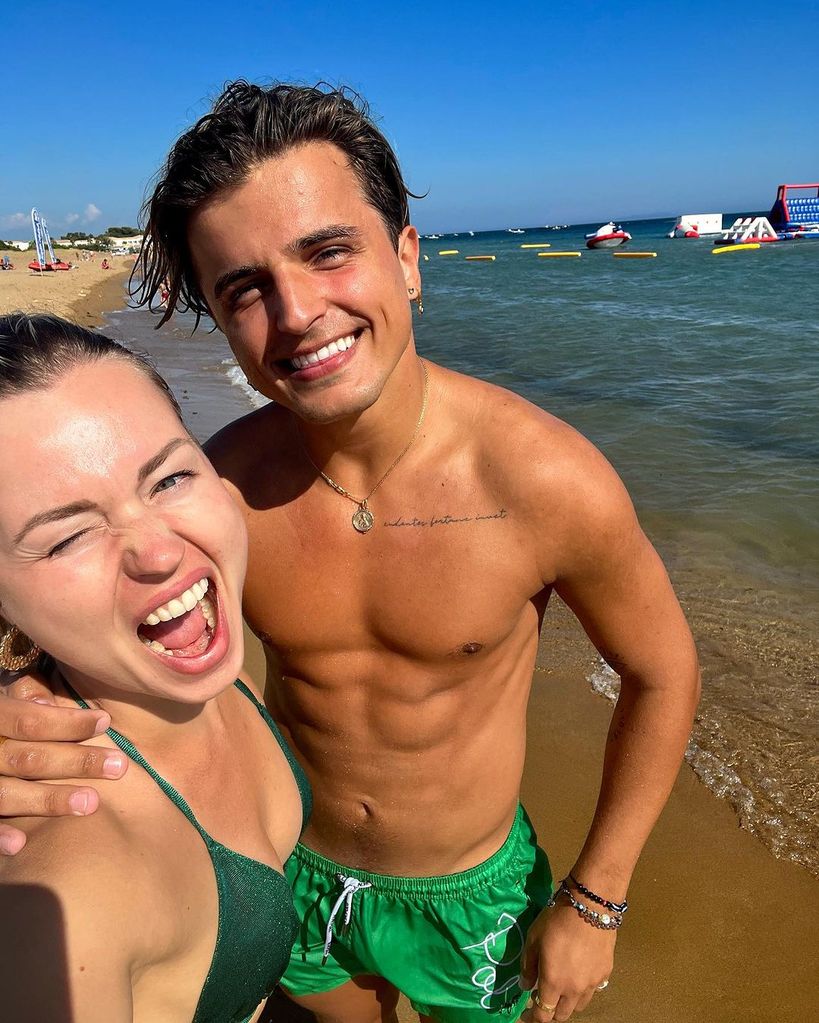 Anastasia and Nikita pose for selfie on beach