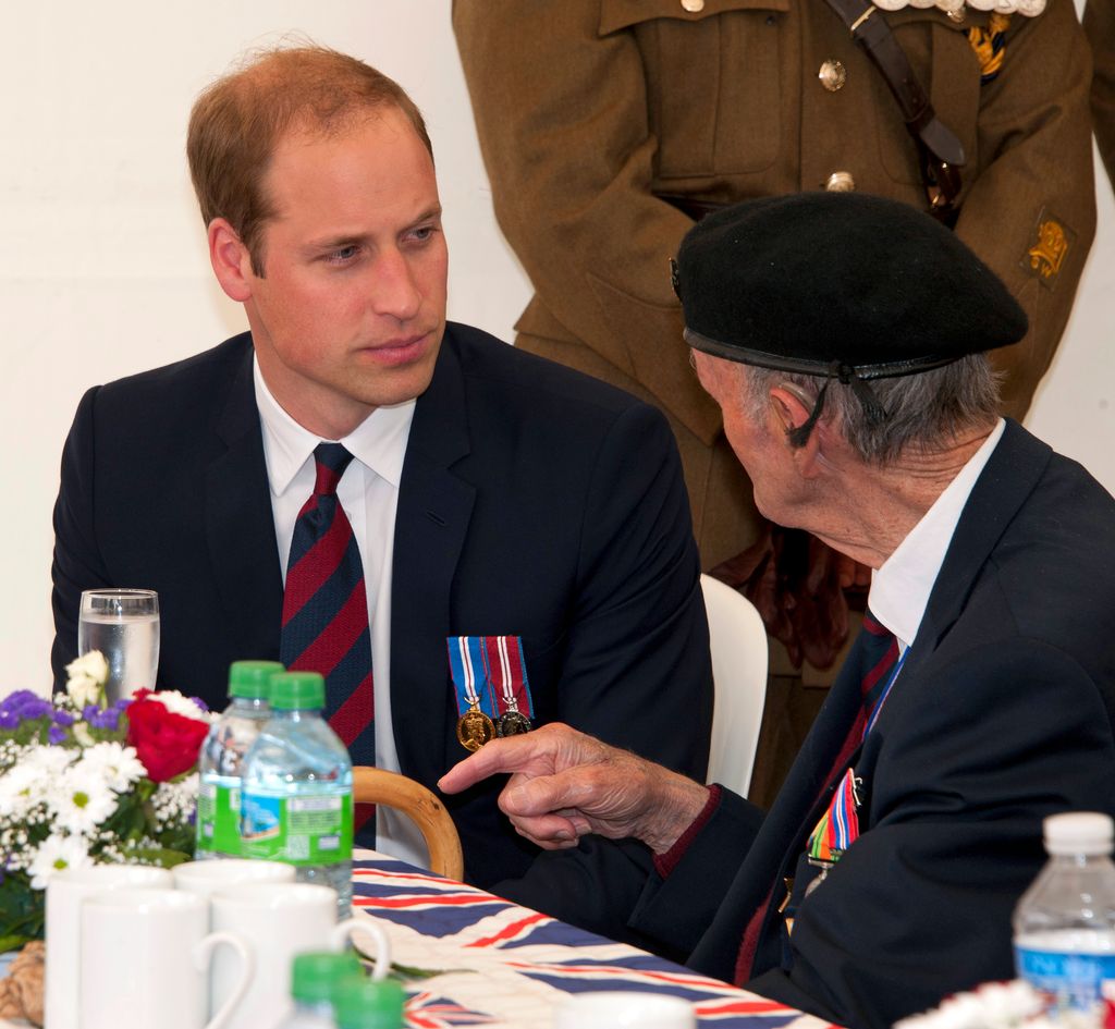 Prince William listening to a war veteran