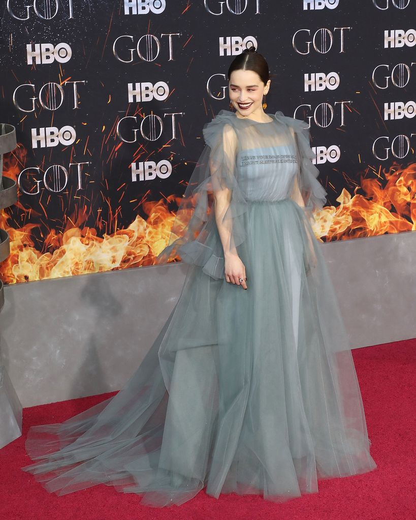 Emilia Clarke in grey dress on red carpet