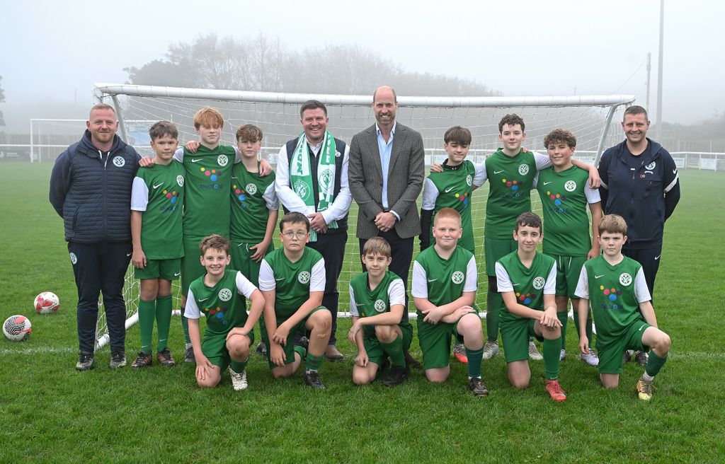 William posed with players from the youth team