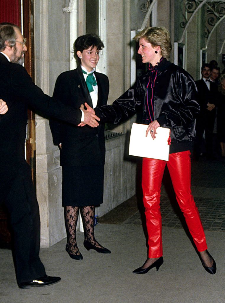 Princess Diana shaking man's hand in red leather trousers