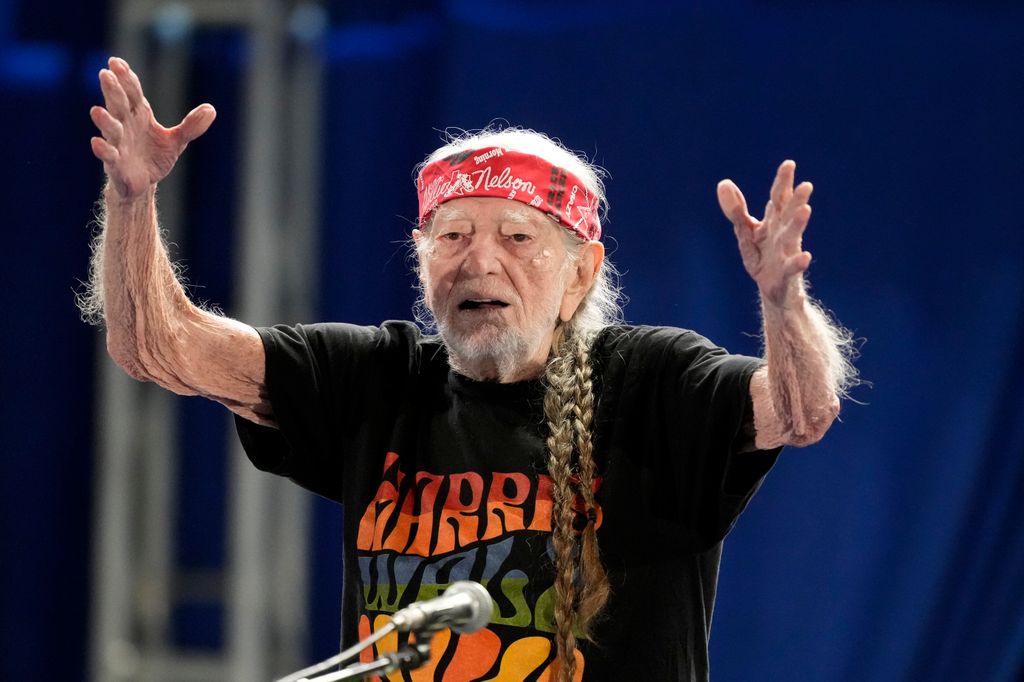 Willie Nelson blows a kiss to the crowd after performing at a Vice President Kamala Harris rally 