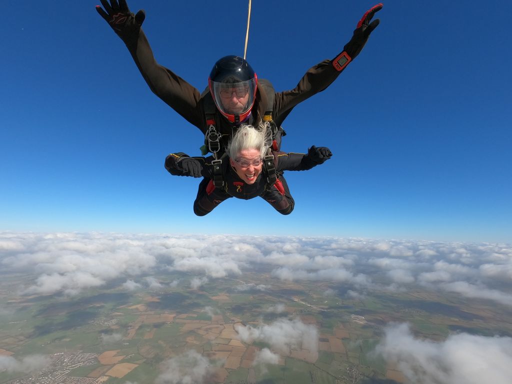 Woman with grey hair skydiving