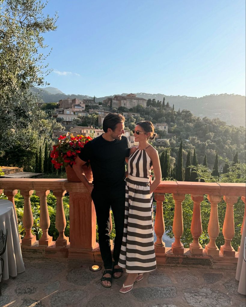 couple gazing at each other on balcony