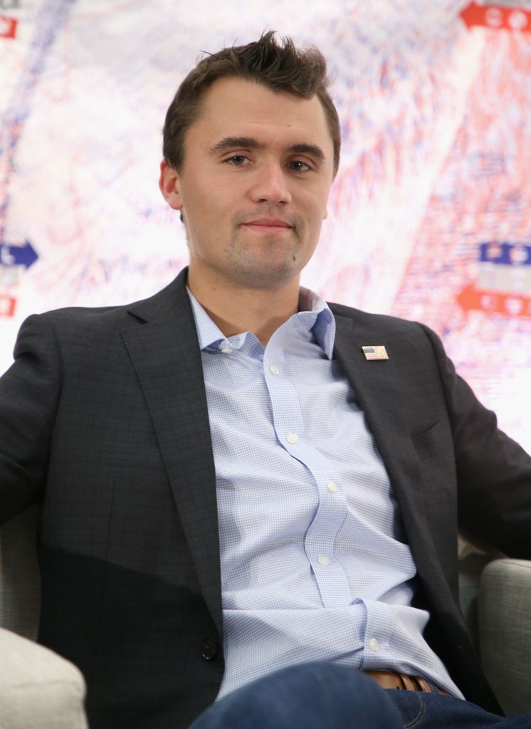 Charlie Kirk at political event wearing a blazer and shirt
