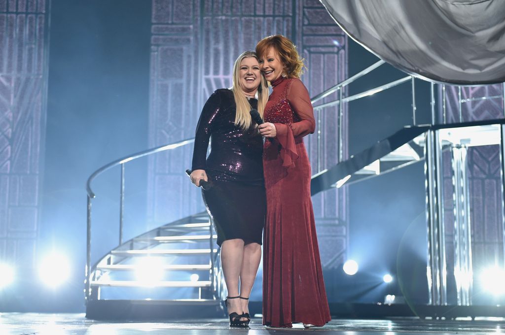 Kelly Clarkson (L) and Reba McEntire perform onstage during the 53rd Academy of Country Music Awards at MGM Grand Garden Arena on April 15, 2018 in Las Vegas, Nevada
