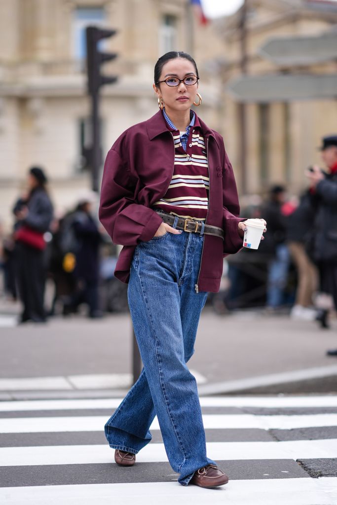 Yoyo Cao opts for a striped polo shirt teamed with denim for the Miu Miu AW24 show in Paris.