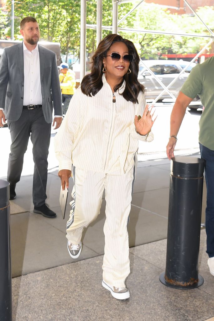 Oprah Winfrey walking in white tracksuit