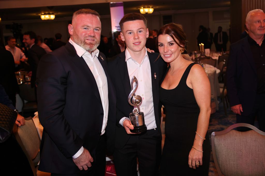 Wayne Rooney standing with Kai and Coleen Rooney