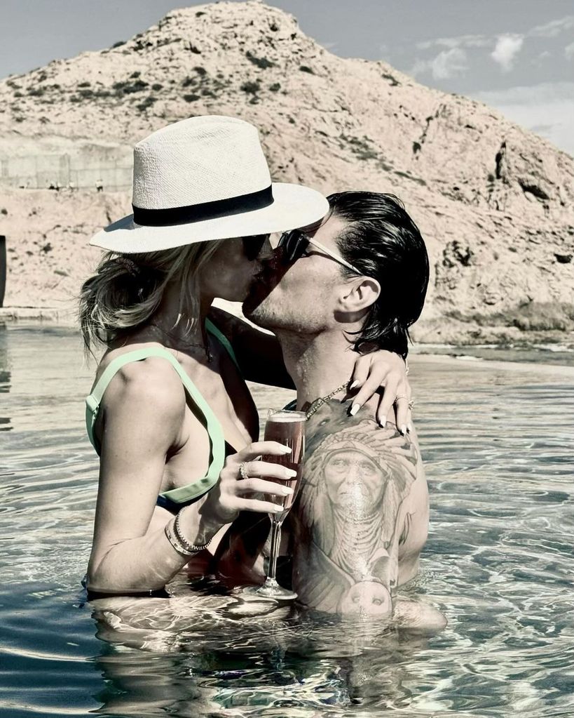 Christina Hall and Josh Hall kiss in the water in Mexico